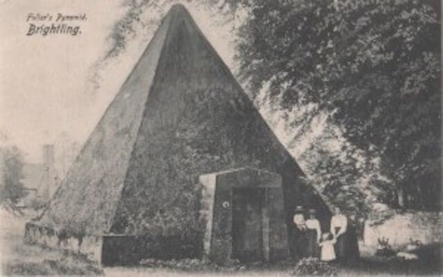 A historic snapshot of a pyramid structure featuring a victorian family.